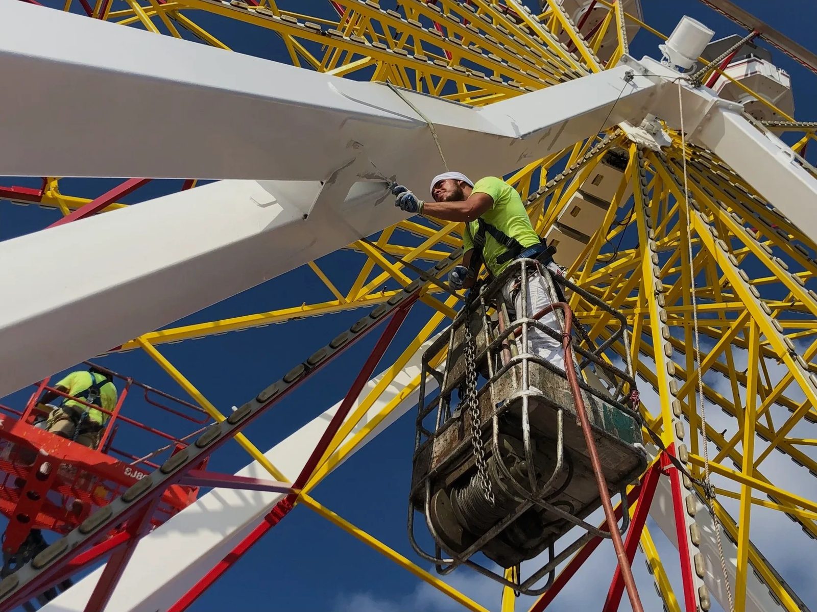 Crew refinishing a Ferris wheel on site